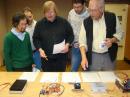 ARRL Lab Engineer Bob Allison, WB1GCM (center), presents the results of his lab evaluations to the Challenge judges as he discusses the features of each entry. Left to right: ARRL Sr Lab Engineer Zack Lau, W1VT; W1AW Station Manager Joe Carcia, NJ1Q; Bob Allison; ARRL Contest Manager Sean Kutzko, KX9X, and QST Technical Editor Joel Hallas, W1ZR. Judges not in the photo: ARRL Lab Manager Ed Hare, W1RFI, and QEX Editor Larry Wolfgang, WR1B. [S. Khrystyne Keane, K1SFA, Photo] 
