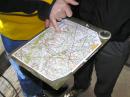 Multi-color orienteering maps of the forest, used for navigation and plotting of bearings, will be provided to each participant just before the competition begins. This hunter mounts his map on a flat surface with his compass.